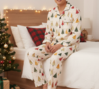 East Asian man wearing the complete Spring Christmas Tree matching pajama set fully covered in a festive bedroom