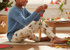 Afro Latino child wearing Spring Christmas leggings with a blue top in an indoor holiday craft room
