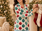 Holiday pajama top with icy blue pants beside fireplace