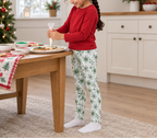 Child wearing Green Snowflake kids leggings while decorating holiday cookies