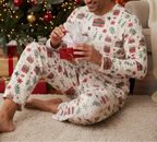 South Asian man wearing the complete Christmas Present matching pajama set while opening a holiday gift