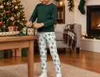 Child wearing Green Snowflake kids leggings while wrapping a holiday gift