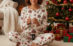 Latina woman wearing the complete Christmas Present women’s pajama set with matching pants in a Christmas living room
