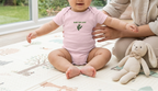 Baby wearing the pink Baby Bay Leaf onesie.