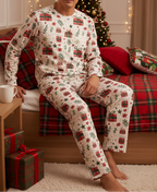 East Asian man wearing the complete Christmas Present matching pajama set in a festive bedroom