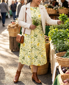 Yellow floral midi dress with an ivory leather jacket at an herb market