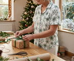 Green Snowflake short sleeve pajama top while wrapping a gift