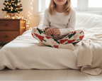 Child wearing Christmas tree leggings in a bright Christmas bedroom
