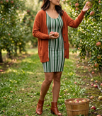 Gathering apples in Green Striped dress and rust cardigan