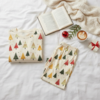Spring Christmas tree-print men’s pajama top and pocketless pants on white bedding
