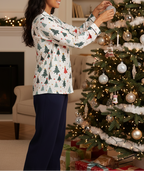 South Asian woman wearing the Blue Christmas women’s long sleeve pajama top while decorating a Christmas tree