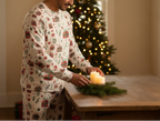 Indigenous man wearing Christmas Present pajamas while arranging a holiday centerpiece