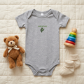 Gray Baby Bay Leaf onesie styled as a flat lay with baby accessories.