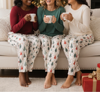 Diverse group of women wearing the Blue Christmas women’s pajama pants in a cozy Christmas lounge