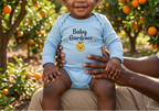 Baby wearing light blue Baby Gardener Orange Onesie beside orange trees