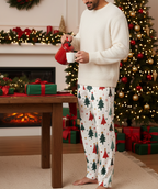 Middle Eastern man wearing the Blue Christmas Tree men’s pajama pants fully covered while pouring hot cocoa