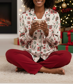 Black woman wearing the Christmas Present women’s long sleeve pajama top in a Christmas living room