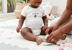 Baby modeling the white Baby Bay Leaf onesie.