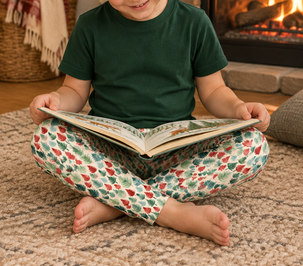 Boy in Leafy Dreams leggings reading by the fireplace