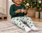 Toddler wearing Green Snowflake kids leggings with wooden snowflake ornament indoors