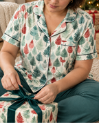 Leafy Dreams women's short sleeve pajama top while tying a gift ribbon