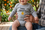 Baby wearing heather gray Baby Gardener Orange Onesie with orange trees behind