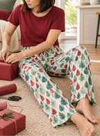 Leafy Dreams women's pajama pants wrapping presents on the floor