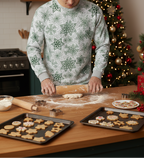 White man wearing a matching green snowflake long sleeve crew neck pajama set while preparing Christmas cookies in a festive kitchen