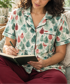 Leafy Dreams women's short sleeve pajama top while reading a journal