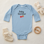 Light blue Raspberry onesie styled flat lay
