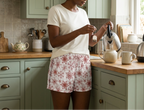 Making tea with an ivory pajama top