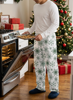 Man baking cookies in Green Snowflake pants and a white shirt
