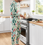 Man in Leafy Dream Christmas tree pajamas cooking in a bright kitchen