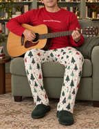 Man in red tee and tree pants playing guitar in a home library