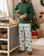Man mixing batter in Green Snowflake pants and a green shirt
