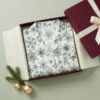 Square-folded white-trim Green Snowflake pajama top in a luxury gift box