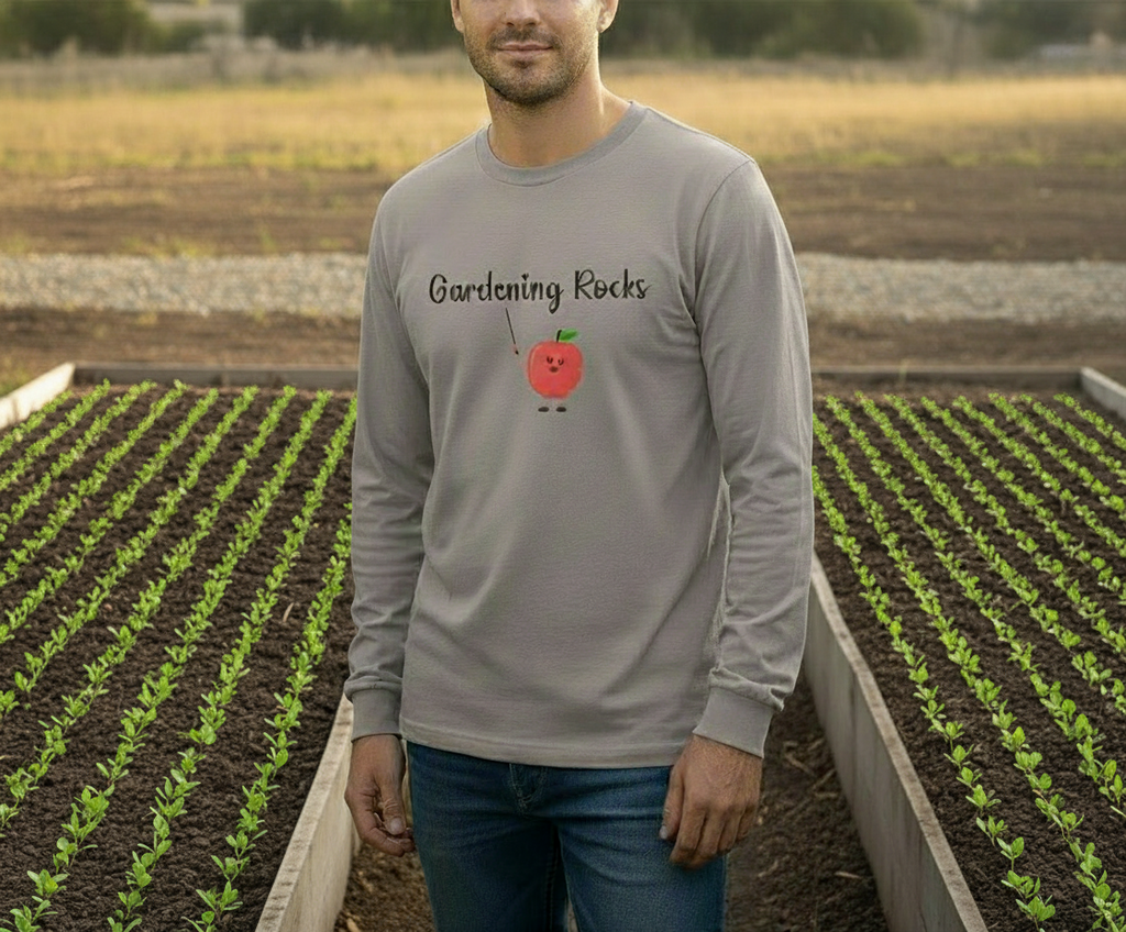 Man wearing a gray long-sleeve shirt with 'Gardening Rocks' text and an apple graphic, standing in a garden.