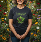 A woman standing in a colorful flower garden wearing a black graphic t-shirt that reads 'GARDENING GRANDMA' above an illustration of green and red garden leaves.