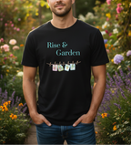 A man wearing a black graphic t-shirt with the text 'Rise & Garden' and a small 'GARDEN' clothesline graphic, set against a blurred garden background.