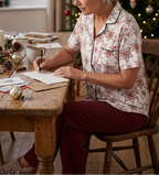 Writing holiday cards with burgundy lounge pants